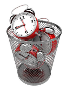 wasting time - A waste basket filled with clocks