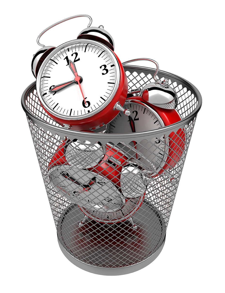 wasting time - A waste basket filled with clocks.